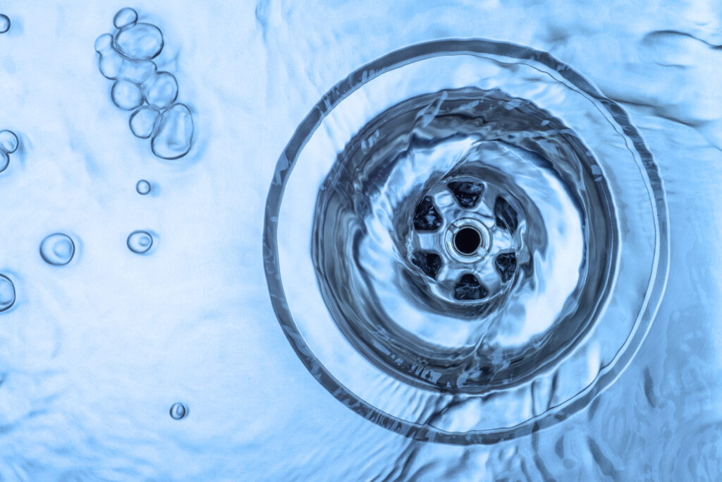 Close-up of water draining in an aluminum kitchen sink