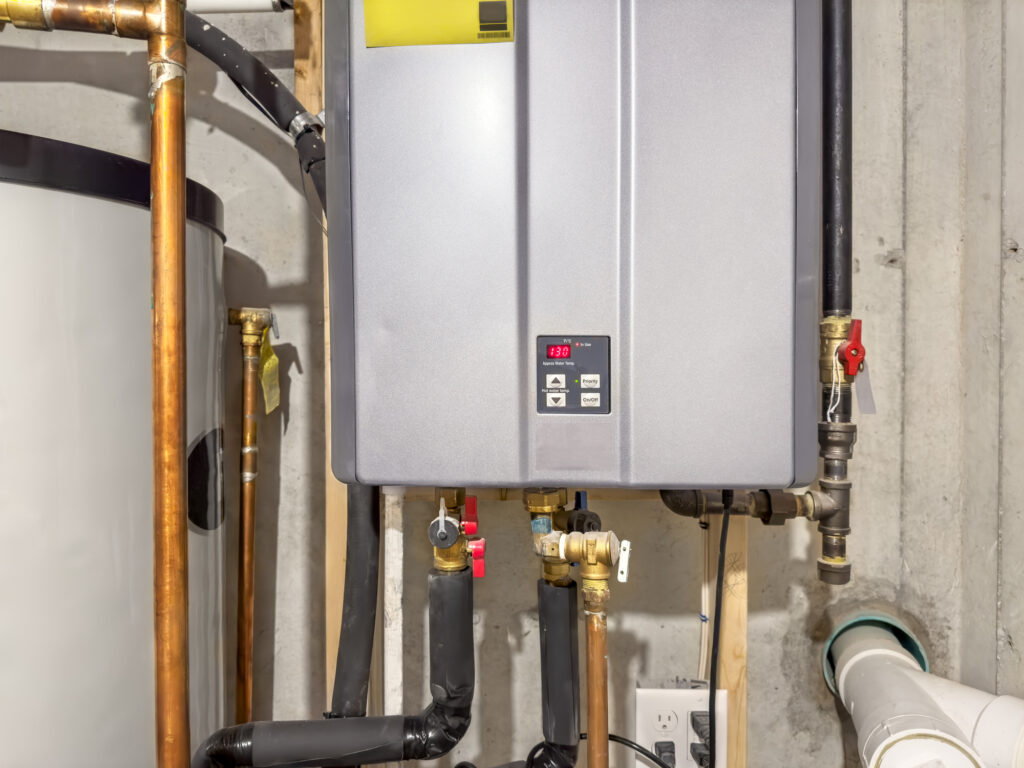 Gray tankless water heater installed in a home.