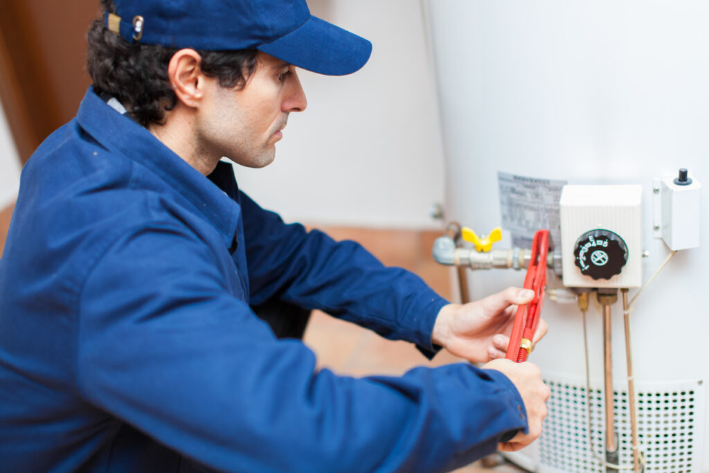 Plumber fixing a tank water heater